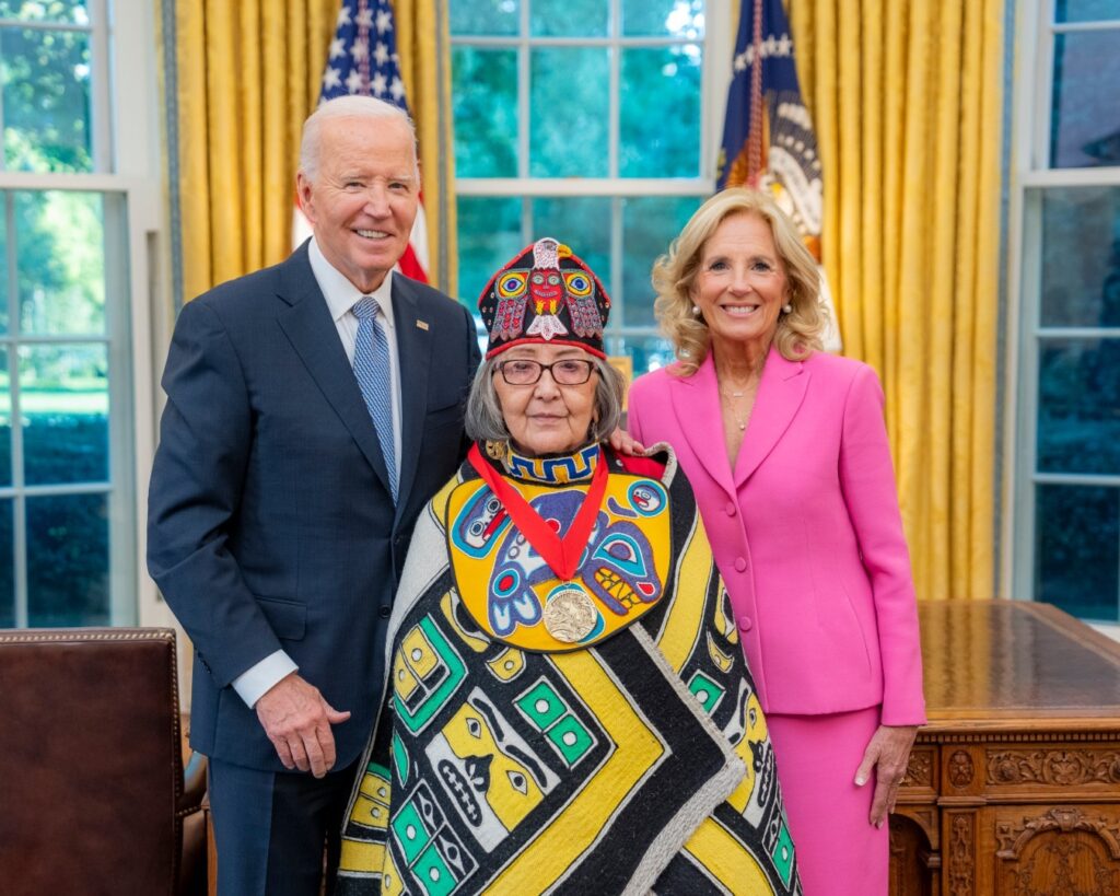 Today is Native American Heritage Day, and we're reflecting on a historic moment in the journey toward healing. Last month, President Joe Biden issued a long-overdue apology for the U.S. government's boarding school policy that forcibly separated Native children from their families, stripped them of their cultural heritage and caused immense harm for over 150 years.

At the Gila River Indian Community, President Biden acknowledged the deep pain caused by these policies, calling it "a significant mark of shame" in American history. He said, "The federal Indian boarding school policy—the pain it caused—will always be a significant mark of shame." This apology is a crucial step in acknowledging the trauma that continues to affect Native communities.

SHI President Rosita Worl, who was honored with the National Humanities Medal by the President for her work in preserving Native culture, was recognized in Biden's remarks. We are proud of Rosita's leadership and the way she continues to honor our people and cultures.

Let this day remind us of the importance of truth and the power of healing, as we work together to move forward with respect and understanding.

Gunalchéesh, Háw’aa, T’oyaxsúun for walking this path with us.

Caption: Dr. Rosita Worl with President Joe Biden and First Lady Dr. Jill Biden. Photo Courtesy of The White House.
kimmetcalfe's profile picture
kimmetcalfe
 

